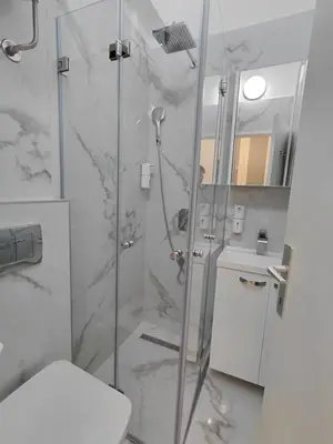 a bathroom with a shower and a toilet at Angel Suites in Belgrade