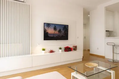 a living room with white walls and a glass table at Belgrade Waterfront Lux Apartments in Belgrade