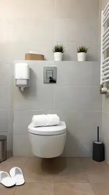 a white bathroom with a toilet and some plants at Belgrade Waterfront Lux Apartments in Belgrade