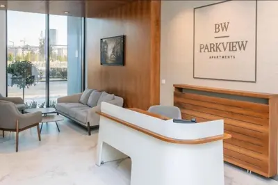 a lobby with a waiting room with a couch and chairs at Belgrade Waterfront Lux Apartments in Belgrade