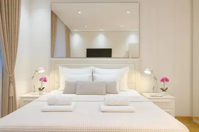 a bedroom with a large white bed with two pillows at Belgrade Waterfront Lux Apartments in Belgrade