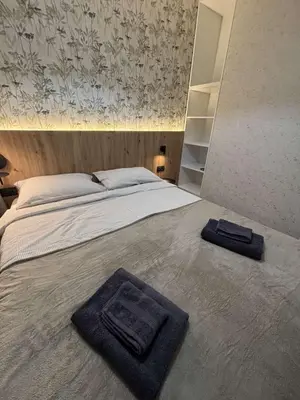 a bedroom with a bed with two towels on it at Urban Nest Belgrade in Belgrade