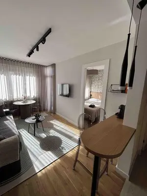 a living room with a table and a couch at Urban Nest Belgrade in Belgrade