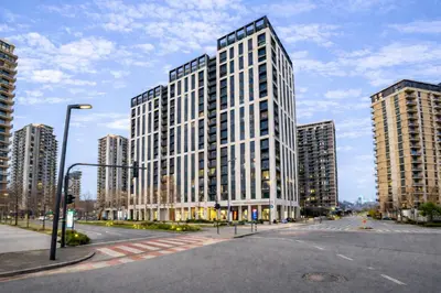 a large white building on a street with tall buildings at Aria BW Lux Apartment in Belgrade
