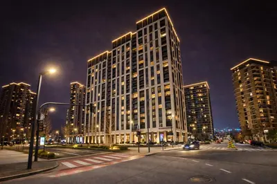 a tall building in a city at night at Aria BW Lux Apartment in Belgrade
