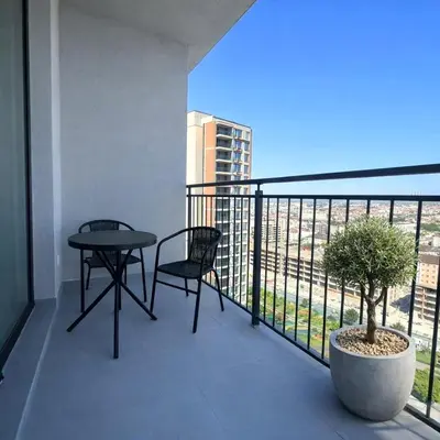a balcony with a table and chair on a building at Aria BW Lux Apartment in Belgrade
