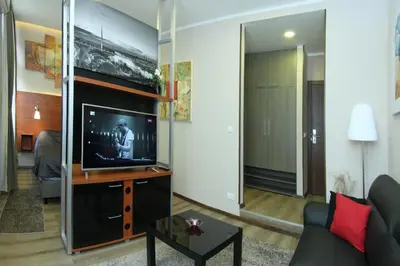 a living room with a tv and a couch at Gala Luxury Suites in Belgrade