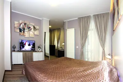 a bedroom with a bed and a television in it at Gala Luxury Suites in Belgrade