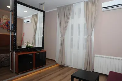 a living room with a mirror and a dresser at Gala Luxury Suites in Belgrade