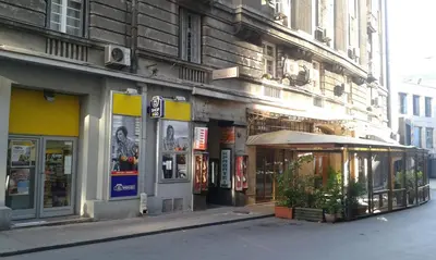 a building on the side of a street with stores at Gala Luxury Suites in Belgrade