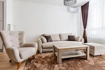 a living room with a couch and a chair at Belgrade Waterfront - Beograd na vodi in Belgrade