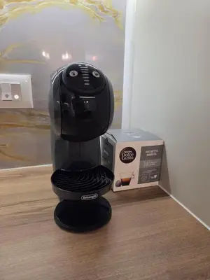 a black coffee maker sitting next to a box at Belgrade Waterfront - Beograd na vodi in Belgrade