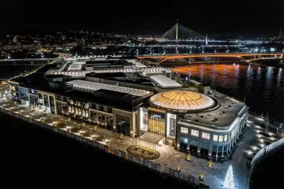 a large building next to the water at night at Belgrade Waterfront - Beograd na vodi in Belgrade