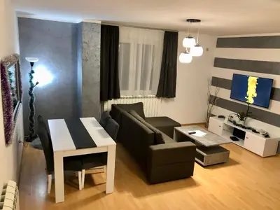 a living room with a couch and a table at Apartman Lav in Bele Vode