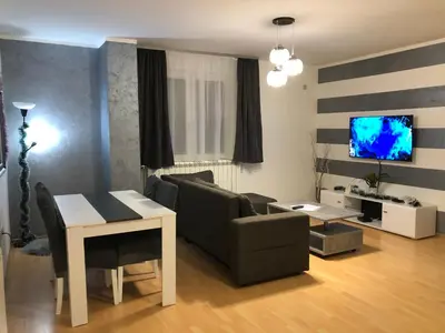 a living room with a couch and a table at Apartman Lav in Bele Vode