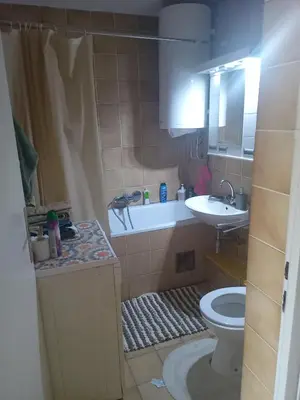 a bathroom with a tub and a toilet and a sink at New Year Loft in Belgrade