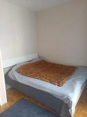 a bed in a corner of a room at New Year Loft in Belgrade