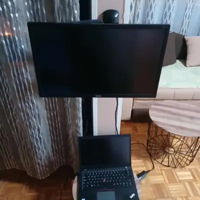 a computer monitor sitting on top of a desk with a laptop at New Year Loft in Belgrade
