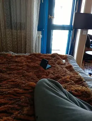 a bed in a room with a book on it at New Year Loft in Belgrade