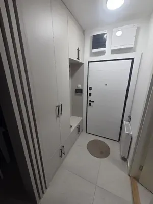 a bathroom with a large white door and a tile floor at Wolf's Wonder in Obrenovac