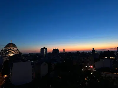 a view of a city skyline at sunset at Temple View Vračar Apartment in Belgrade