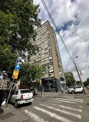 a tall building with cars parked in front of it at Temple View Vračar Apartment in Belgrade