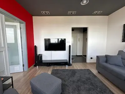 a living room with a couch and a flat screen tv at Temple View Vračar Apartment in Belgrade