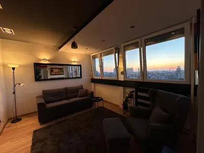 a living room with a couch and a view of a city at Temple View Vračar Apartment in Belgrade