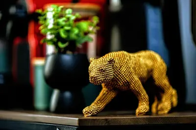 a wooden toy cat walking on a table with a vase at Slavija Central in Belgrade