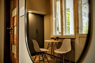 a room with two chairs and a table and a window at Slavija Central in Belgrade