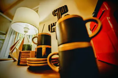 a table with a cup and a lamp on it at Slavija Central in Belgrade
