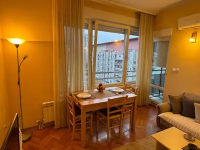 a living room with a table and a couch at Apartment 63 in Belgrade