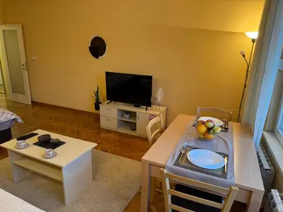 a living room with a table and a television at Apartment 63 in Belgrade