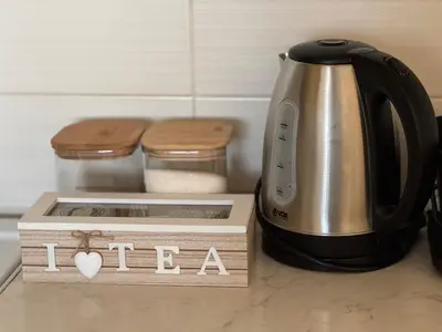 a tea kettle and a box on a kitchen counter at Apartment 63 in Belgrade