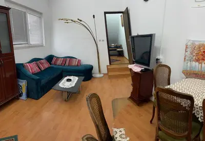 a living room with a blue couch and a tv at Kosmaj-Suncani Breg