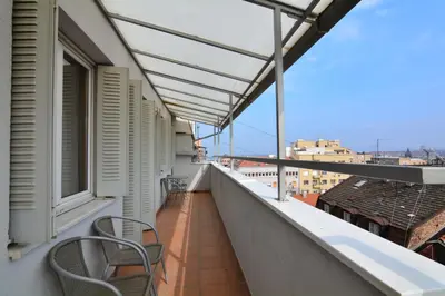 a balcony with chairs and a view of the city at Apartment Dositejeva 13 in Belgrade