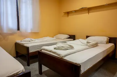 two beds in a room with towels on them at Etno kompleks Deliblatska Čarda in Deliblato