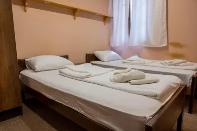 two beds in a room with towels on them at Etno kompleks Deliblatska Čarda in Deliblato