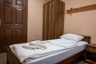 a bedroom with a bed with towels on it at Etno kompleks Deliblatska Čarda in Deliblato