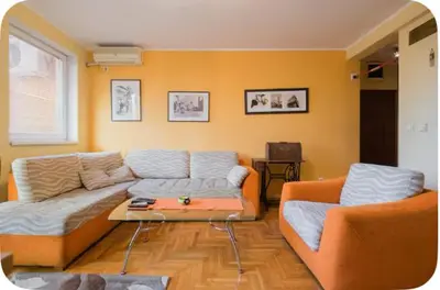 a living room with a couch and a table at Warm and comfortable two rooms flat in Belgrade