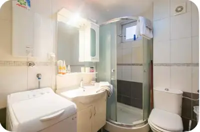 a bathroom with a sink and a toilet and a shower at Warm and comfortable two rooms flat in Belgrade