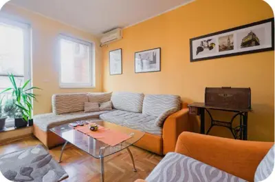 a living room with a couch and a table at Warm and comfortable two rooms flat in Belgrade