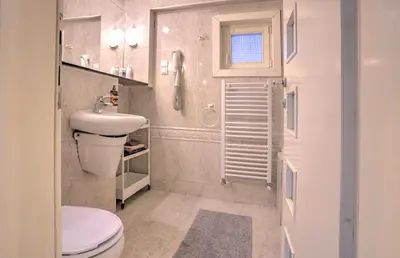 a small bathroom with a toilet and a sink at Kalemegdan Central Apartment II in Belgrade