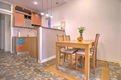 a kitchen with a wooden table and chairs in a room at Kalemegdan Central Apartment II in Belgrade