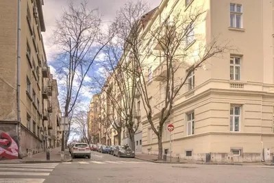 a city street with buildings and cars parked on the street at Kalemegdan Central Apartment II in Belgrade
