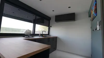a kitchen with a counter and a large window at River House Sunrise in Ritopek