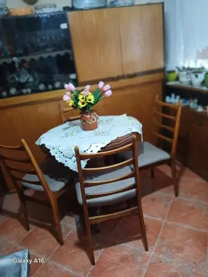 a table and chairs with a vase of flowers on it at Rajka in Belgrade