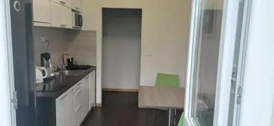 a small kitchen with a sink and a table at LP apartment in Belgrade