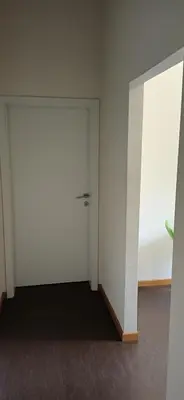 an empty room with a white door and a window at LP apartment in Belgrade