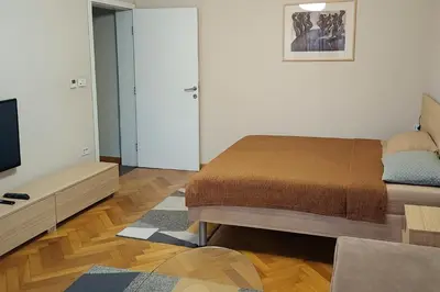 a small bedroom with a bed and a tv at LP apartment in Belgrade